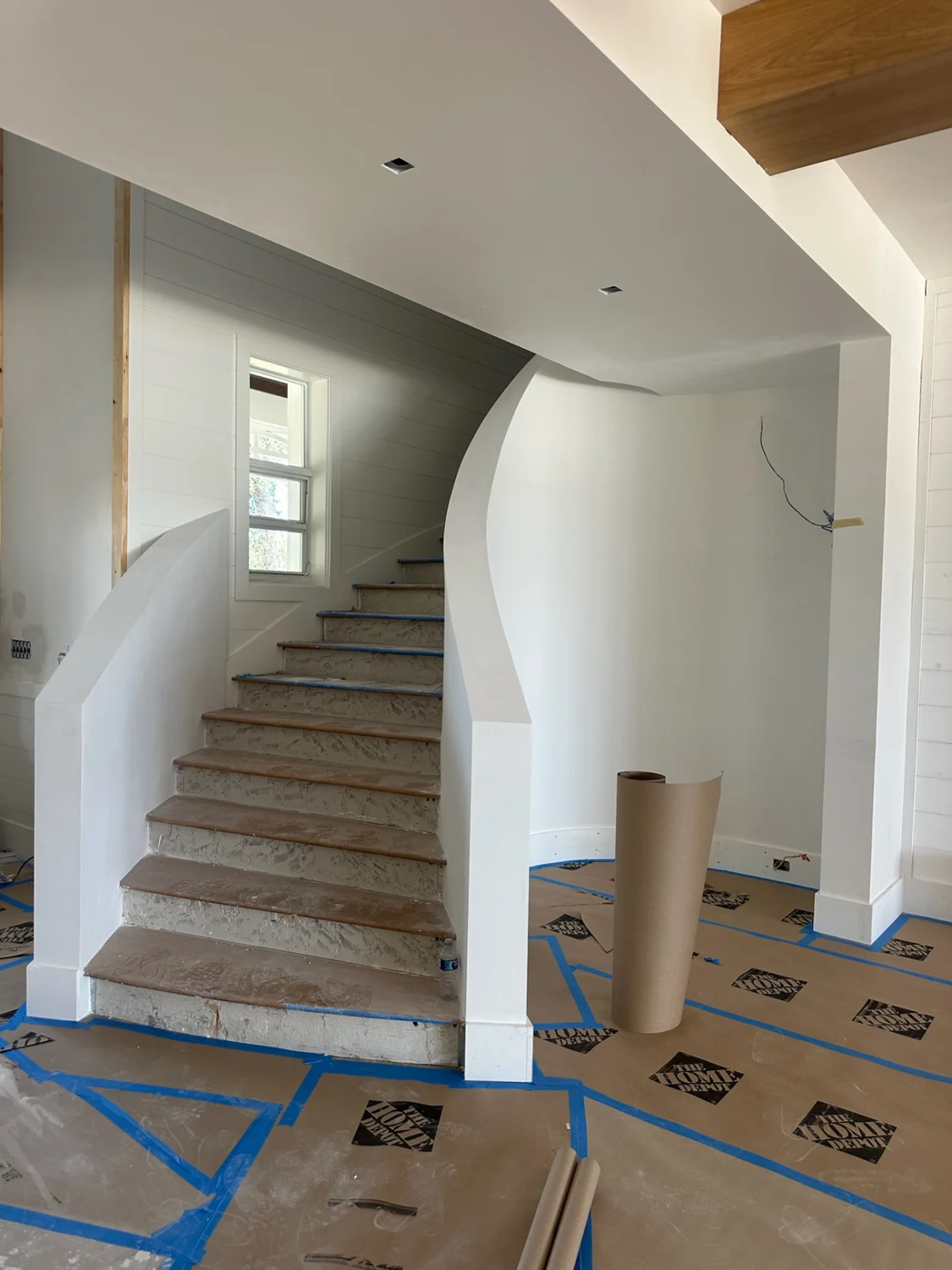 Custom spiral staircase with repaired drywall edges and smooth sloping walls in Sewall's Point, Stuart, FL