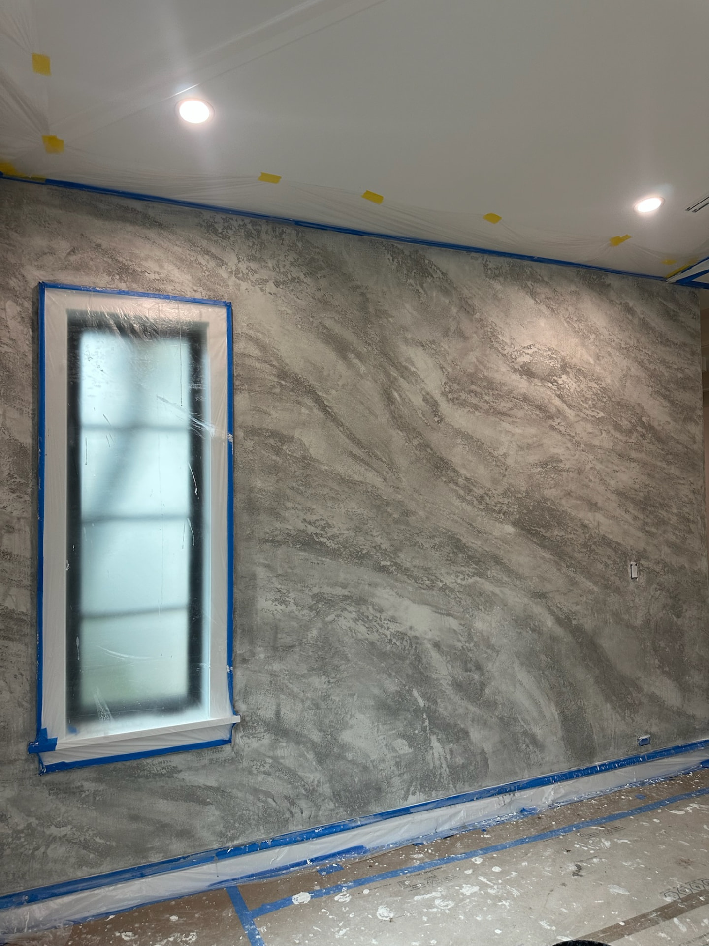 Second plaster coat creating split stone marble texture in greys, West Palm Beach FL
