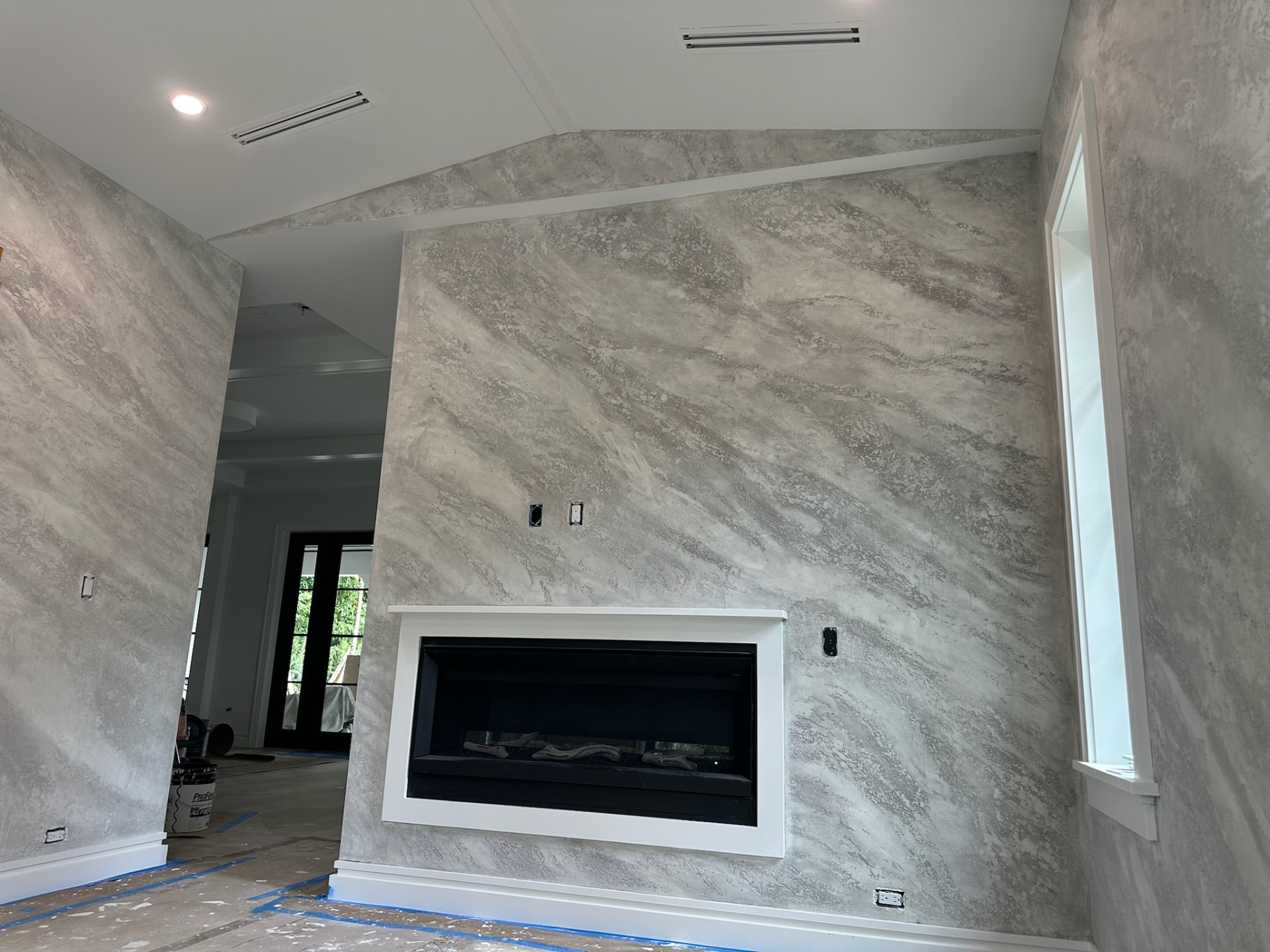 Split stone textured Venetian plaster fireplace wall in grey and white, West Palm Beach FL
