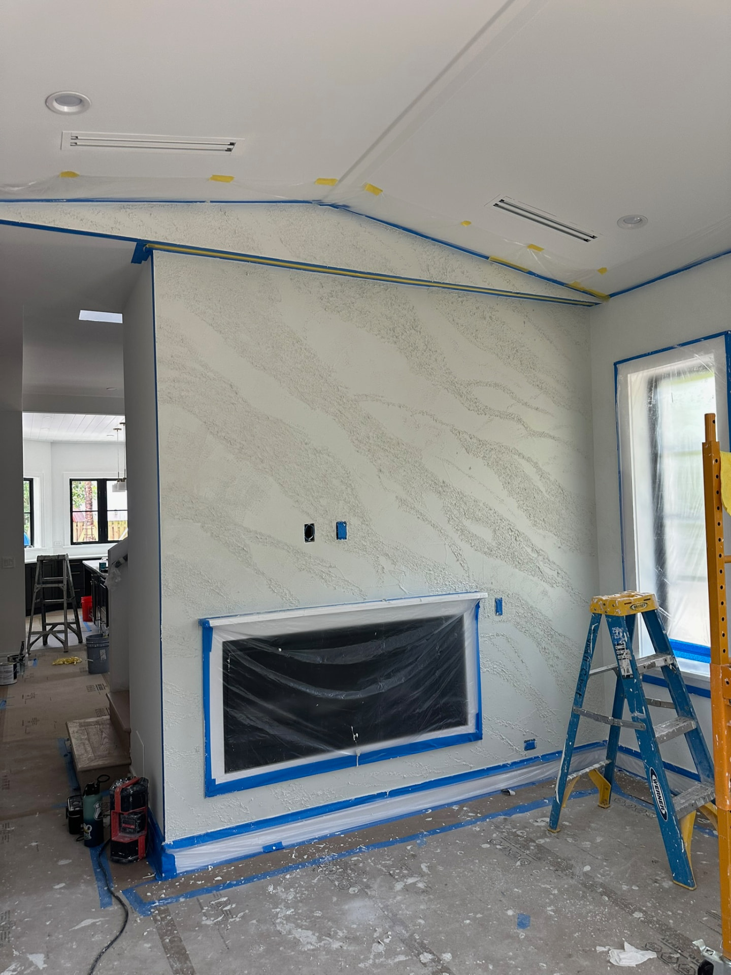 First white plaster base coat on den fireplace wall, West Palm Beach FL