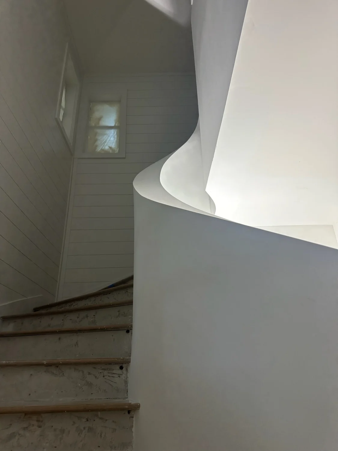 Smooth sloping drywall profile following the custom spiral staircase curve in Sewall's Point, Stuart, FL