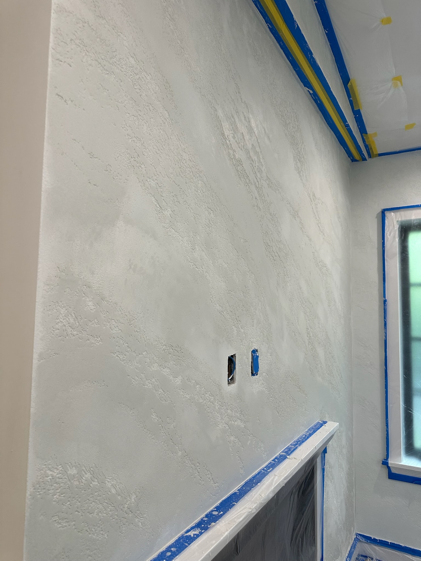 Hand-troweled white plaster texture detail on den wall, West Palm Beach FL
